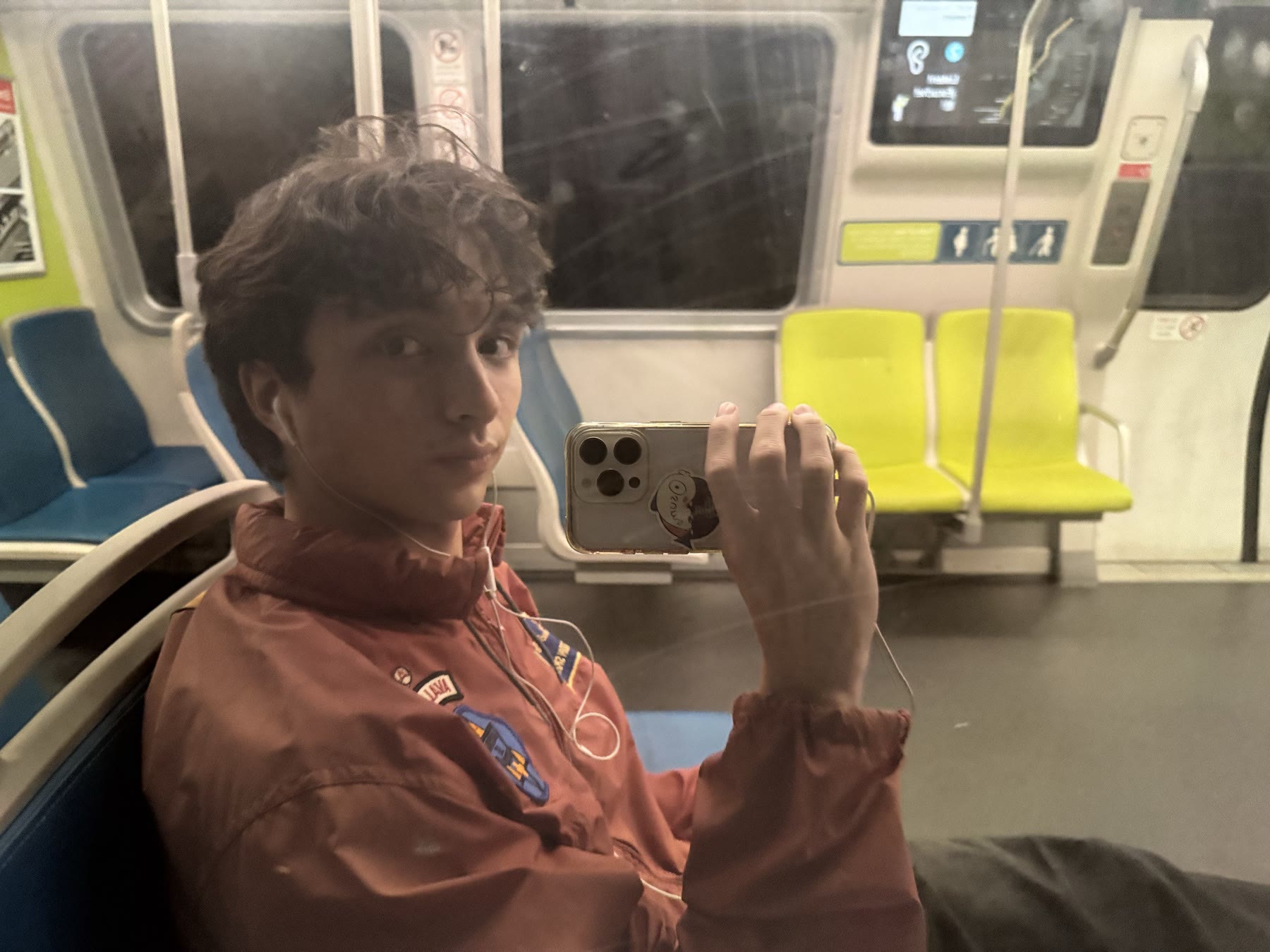 Ben taking a mirror photo on a train