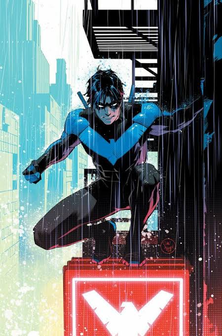 Nightwing crouching above a city